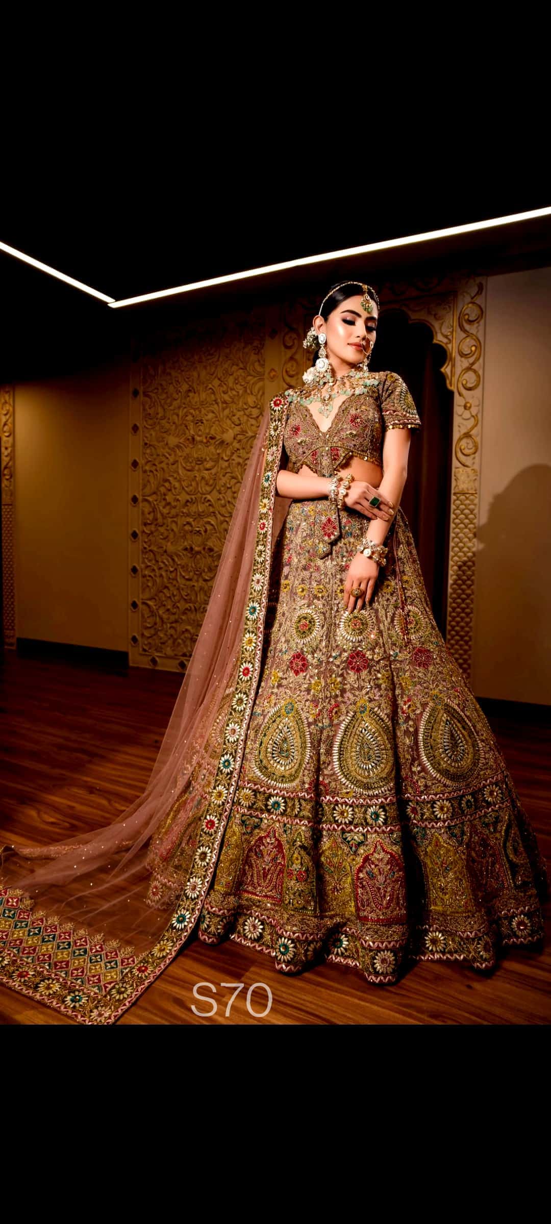Traditional embroidered Wedding Lehenga lehenga with a matching dupatta on a wooden floor.