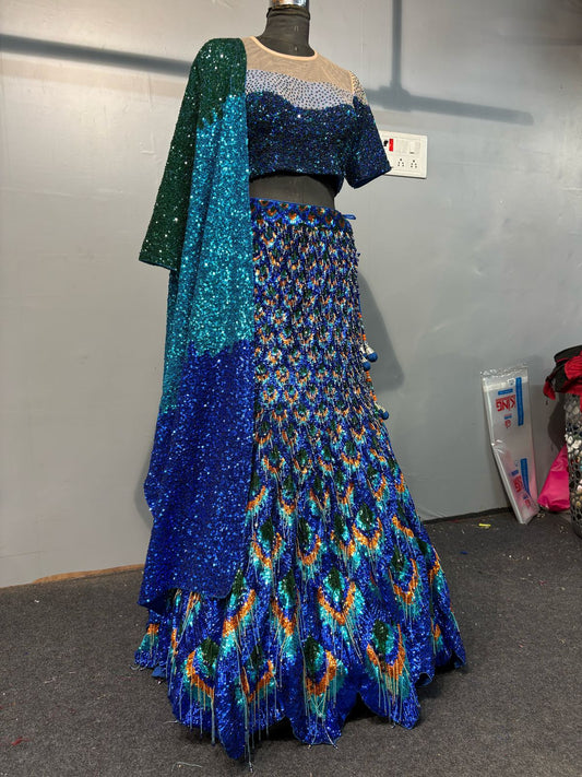 Blue and green sequin dress on a mannequin against a plain background