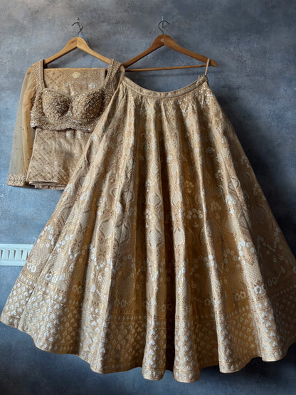 Patterned skirt and top set on hangers against a textured gray wall.