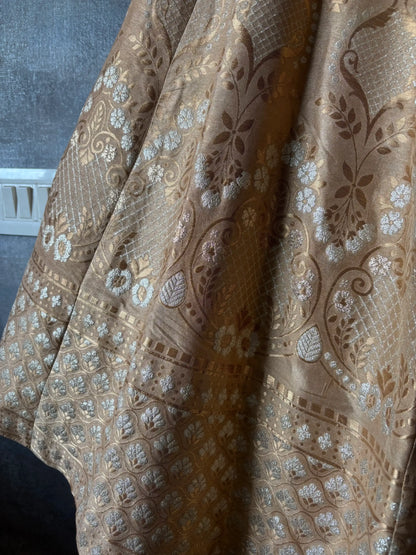 Close-up of patterned fabric with intricate designs on a plain background