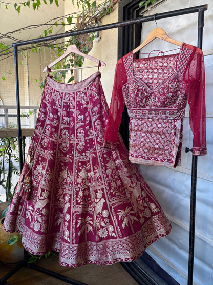 Maroon and white patterned traditional outfit on a rack with a blurred indoor background