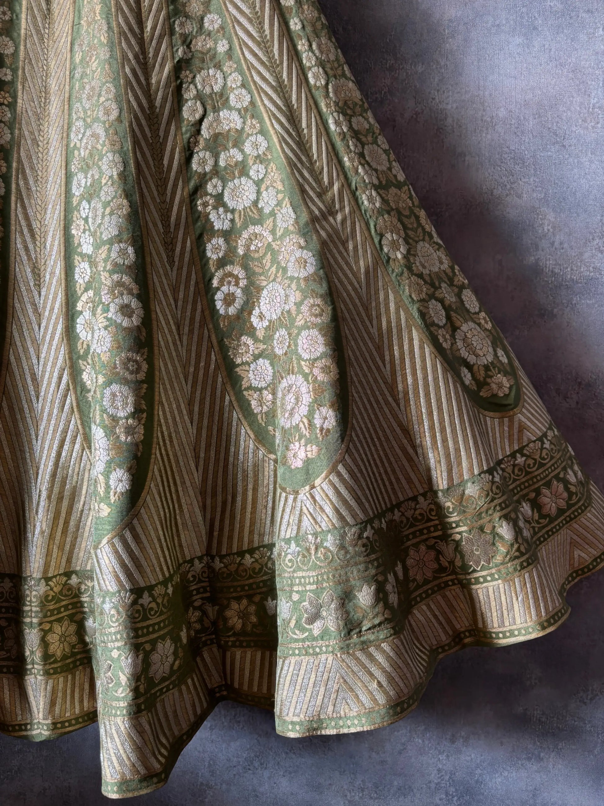 Embroidered fabric with intricate patterns on a textured surface