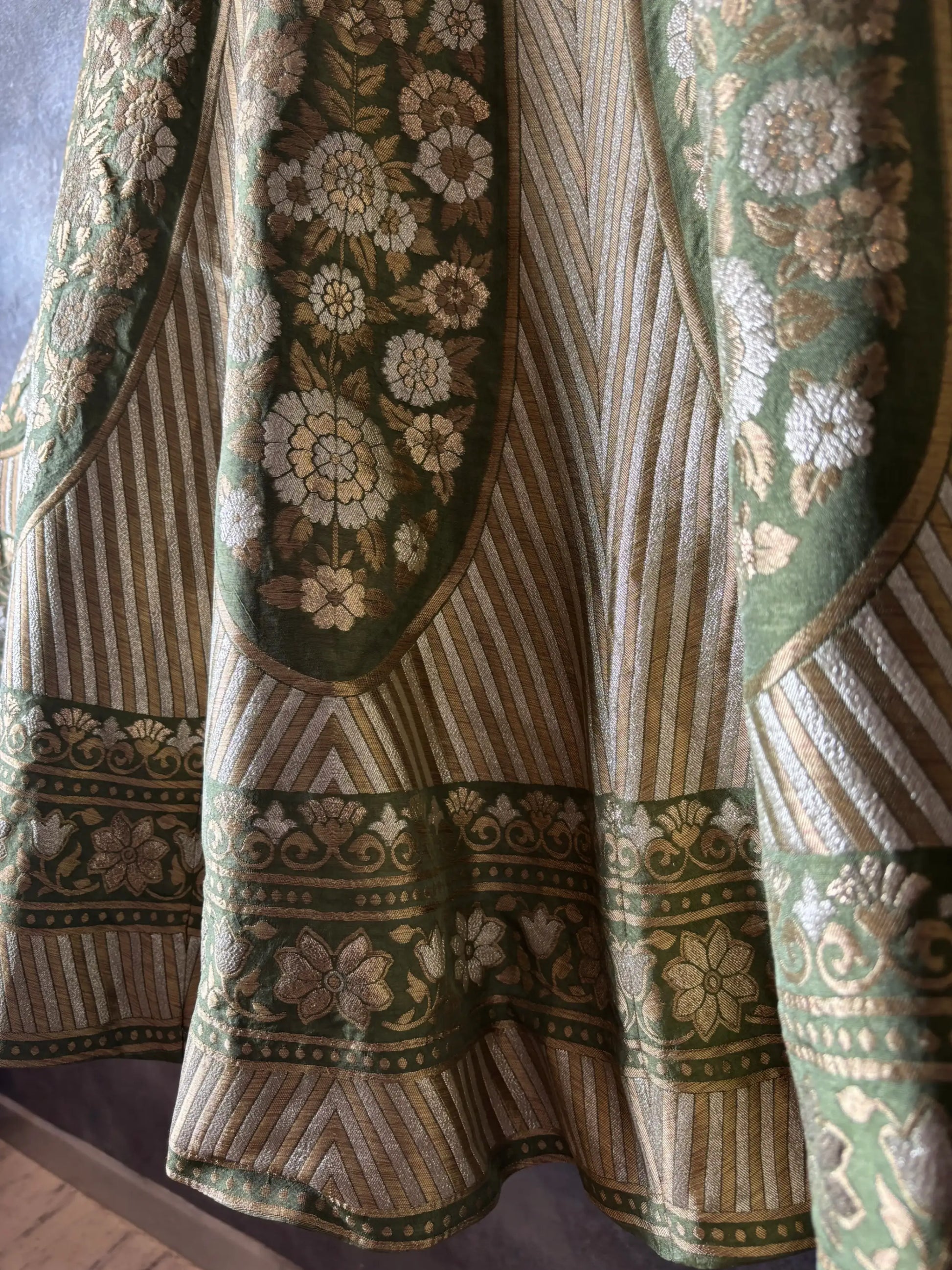 Close-up of a patterned fabric with floral and geometric designs.